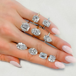 four various engagement ring styles on ladies hand